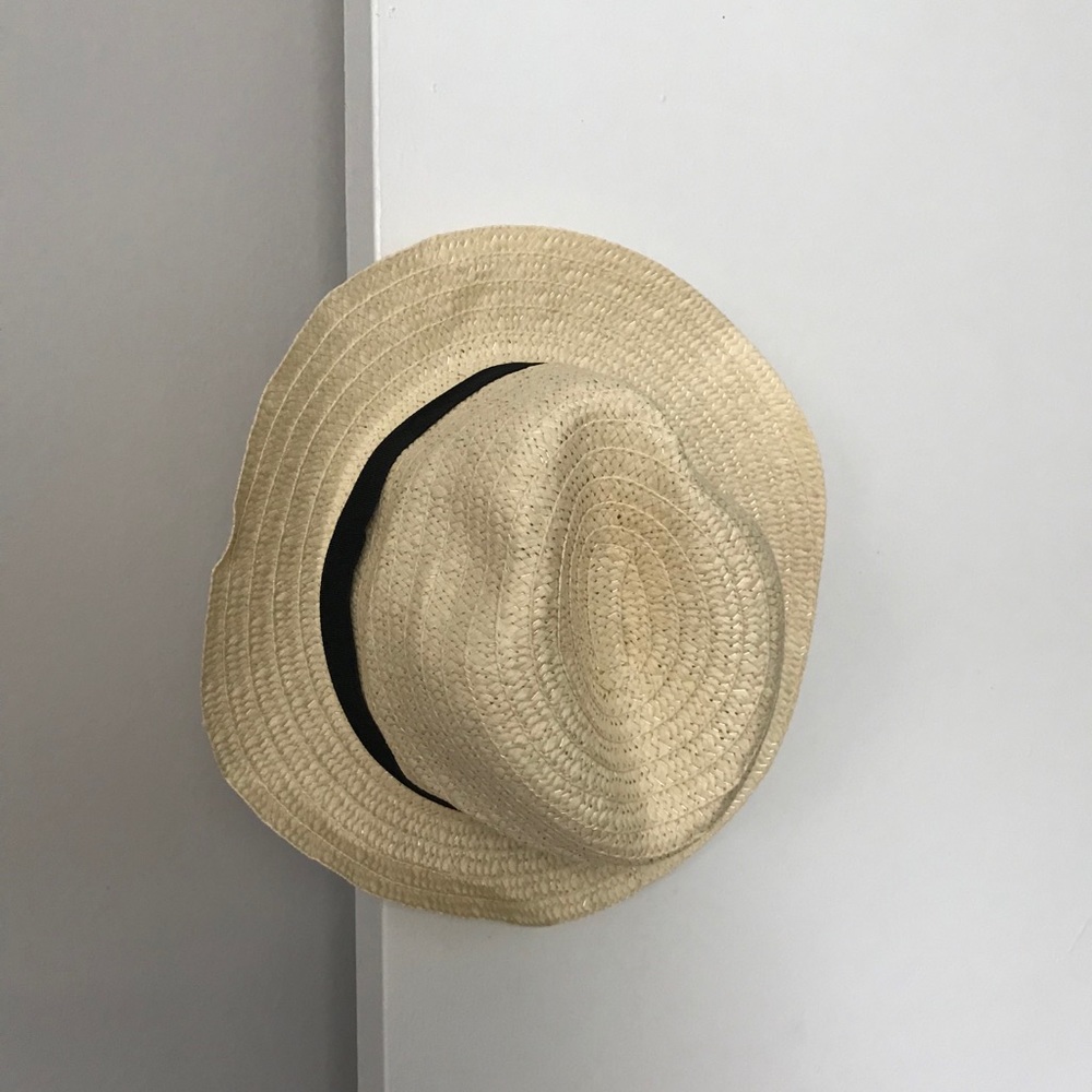 Tan straw hat with black band around the top